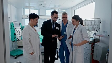 Pharmaceutical sales respresentative showing doctor new medications. Group presentation in hospital setting.