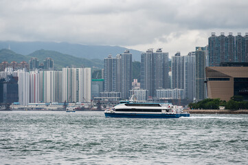 Photo of buildings under construction in Kowloon on a cloudy day. View from Hong Kong Island