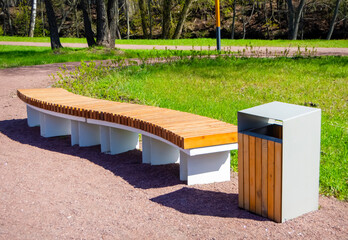 Wooden modern bench in the park. Landscape design