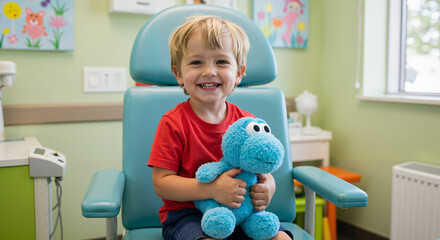 Young boy smiling while holding stuffed toy in pediatric clinic  