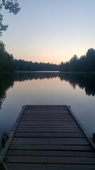 Empty dock with a calm view of the lake at dawn.