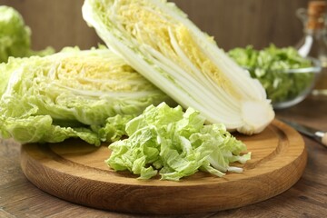 Fresh cut Chinese cabbage on wooden table, closeup