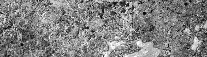 Close-up of volcanic stone wall with irregular surface, wide view.Ideal for use in design, 3D modeling, game environments, and architectural backgrounds.High quality. Copy space. 