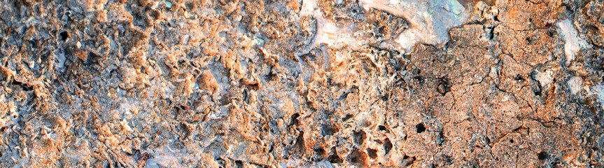 Horizontal close-up shot of rough volcanic stone with irregular surface, textured background.Ideal for use in design, 3D modeling, game environments, and architectural backgrounds.