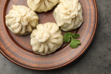 Delicious khinkali served on grey table, top view