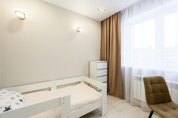 cozy room featuring a white wooden bed frame, a desk, a chair, and a window with sheer and brown...