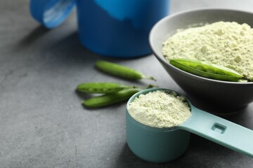 Protein powder and green peas on grey table, closeup. Space for text