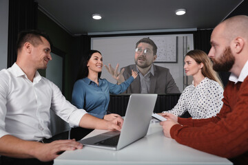 Group of people participating in business conference indoors. Speaker on projection screen
