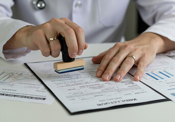 Doctor stamping medical record form for approval healthcare and medicine business concept image stock photo