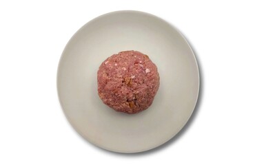 Top view of a raw patty (Bifteki in Greek), round and flat, made from beef meat, isolated on a white background, ready for cooking or preparation.