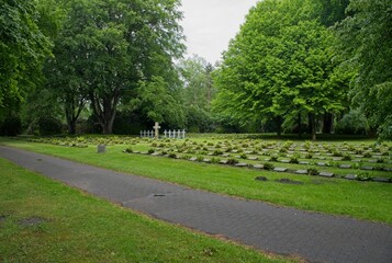 Hamburg, Germany - May 25, 2025: The Friedhof Ohlsdorf Cemetery in Hamburg  contains about 1229 polish war graves from Second World War. Cloudy spring day. Selective focus