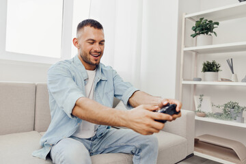 Engaged man playing video games at home, enjoying a digital escape while balancing work-life...