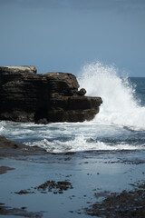 BALI, INDONESIA Beach and breaking Indian Ocean waves, Bali. Tanah Lot Temple