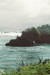 BALI, INDONESIA Beach and breaking Indian Ocean waves, Bali. Tanah Lot Temple