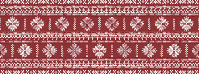 Traditional red and white textile with intricate geometric and floral patterns in a repetitive horizontal layout.
