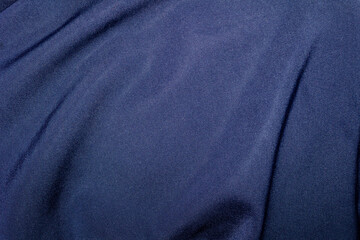 Fototapeta premium High-resolution Close-Up of Rippled Blue Linen Fabric with Visible Natural Folds and Textile Fibers. Ideal for Use in Textile Design, Fashion Mockups, or Elegant Background Textures.