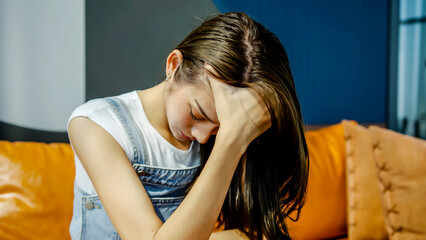 Sad young asian woman sit alone feel depressed lonely. Upset single lady thinking of health problem...