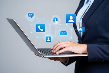 Businessperson using laptop with communication icons representing digital connections and accessibility