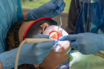 Skilled dental professional performing treatment in modern clinic setting