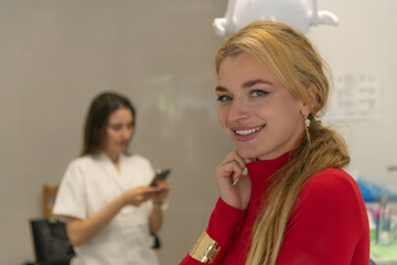 Dentistry practice in a clinic with smiling patient and staff member