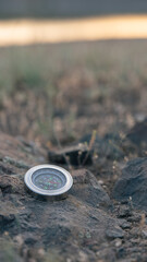 Metal Compass on Rocky Ground – Outdoor Navigation Symbol