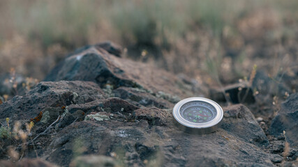 Metal Compass on Rocky Ground – Outdoor Navigation Symbol
