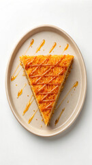 Delicious slice of sweet cake with syrup drizzled on a beige plate food photography