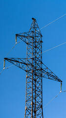 Electric Transmission Tower on Clear Blue Sky Background