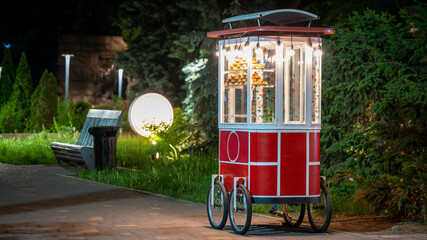 Colorful Street Food Cart with Snacks at Night in City Park