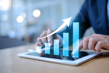 Businessperson using a tablet with a rising growth graph representing financial success