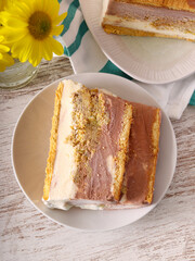 cake with chocolate, vanilla and pistachio layers