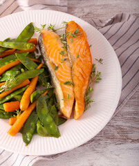 Salmon with baby carrot and pea