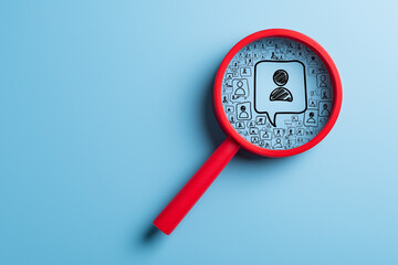 Magnifying glass highlighting the right person among icons. Ideal for target customer, recruitment, or business decision-making concepts