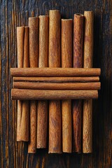 Cinnamon sticks arranged on dark wood