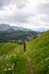 Fototapeta premium Woman Hiker on Alpine Trail with Open Arms