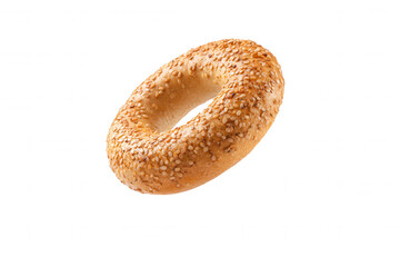 Fresh baked sesame bagel on a black background Closeup of a delicious, golden brown bagel sprinkled with sesame seeds Concept of breakfast, bakery, and food