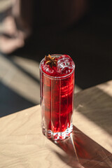 Highball glass of fresh red long cocktail with mint and ice