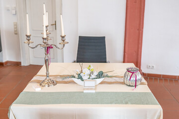 Luxurious wedding setup with round tables, stylish chairs, and beautiful floral decorations creating romantic atmosphere