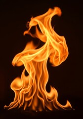 Fototapeta premium Fiery Abstract Blaze - An abstract of a flame, burning bright against a black background. Intense orange and yellow hues