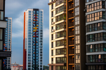 A picturesque row of tall buildings against a bright blue sky in the background