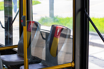 A bus featuring a prominent red button, clearly labeled as emergency