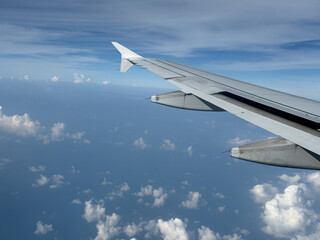the view from air plane window to the clouds, blue sky landscape, traveling concept