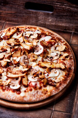Gyros Pizza with with champignons and mozzarella cheese. Wooden background. Soft focus.