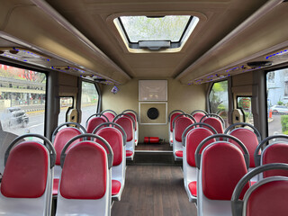 City bus interior. Public transport. top bus or tram interior without passengers. Modern public transport. Seating for passengers.
