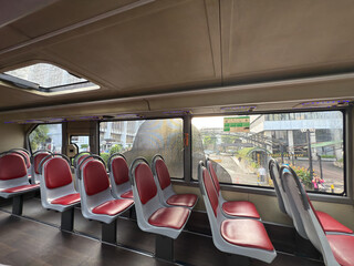 top bus row of seats, City bus interior. Public transport. top bus or tram interior without passengers. Modern public transport. Seating for passengers.