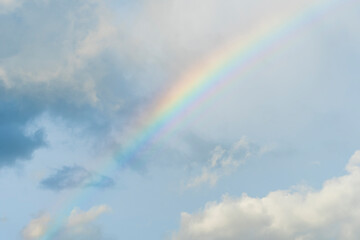 Dramatic blue clouds and rainbow in sunset sky. Amazing sky landscape. The sky that gives happiness and peace