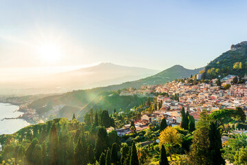 panoramic view of beautiful sunset in old european town with vintage buildings and great mountains...