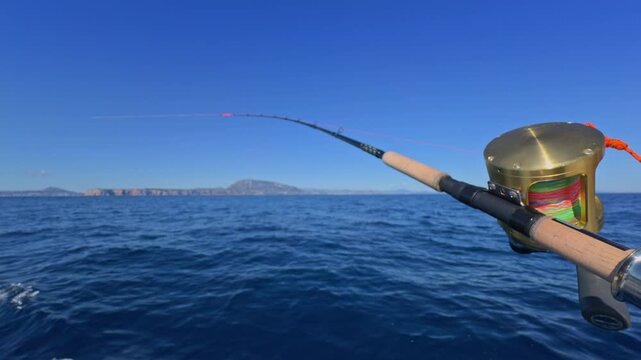 sport fishing boat on ocean sea Rod and gold reel trolling