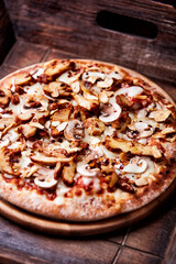 Gyros Pizza with with champignons and mozzarella cheese. Wooden background. Soft focus.