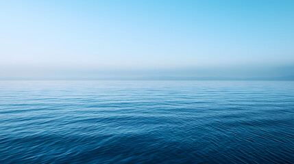 Obraz premium The image is of a calm body of water with a blue color